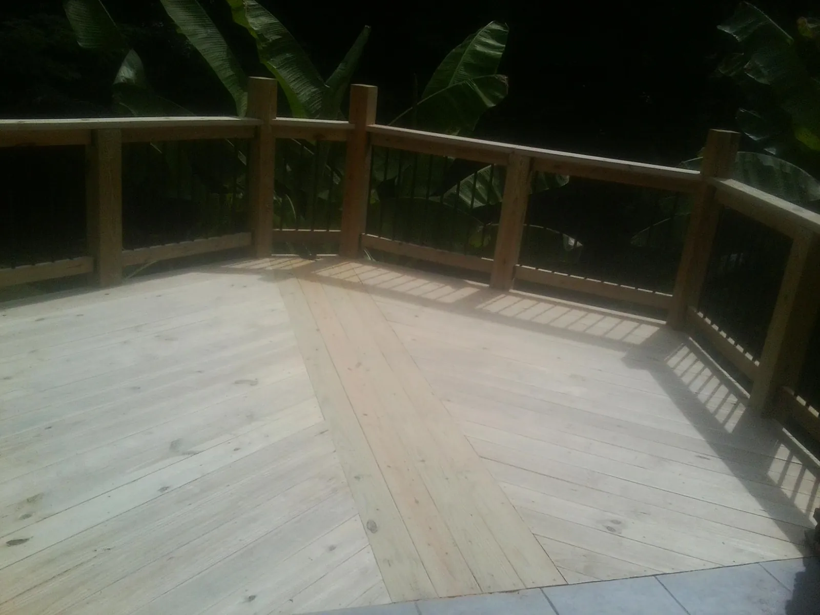 New wood deck and railing built off the back of a home in Shirley